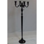 A contemporary floor standing black painted metal candelabra, H.155cm