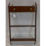 A 20th century mahogany wall hanging shelves with single drawer