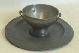 An antique pewter charger with various makers stamps, D.42cm, together with a French pewter tureen