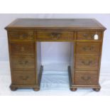 An early 20th century oak kneehole desk, H.77 W.106 D.61cm