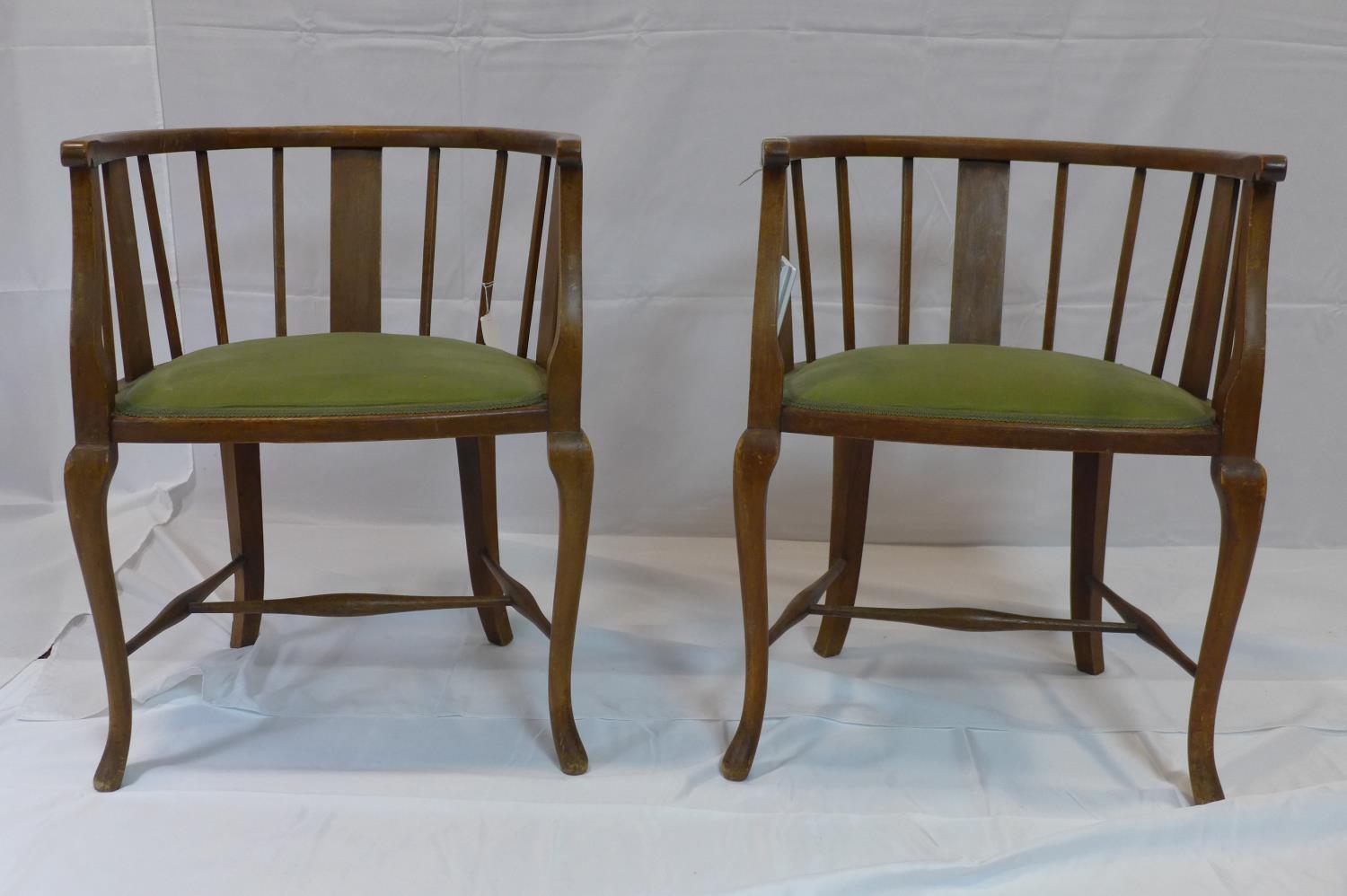 A pair of Edwardian mahogany tub chairs with velour seats