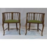 A pair of Edwardian mahogany tub chairs with velour seats