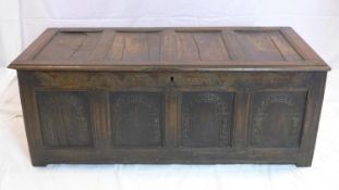 An 18th century oak panelled coffer with carved front, H.53 W.138 D.63cm