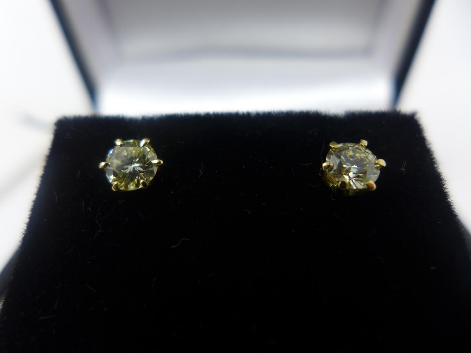 A pair of 18ct yellow gold and solitaire diamond stud earrings, 0.57ct