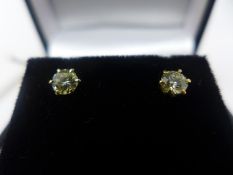 A pair of 18ct yellow gold and solitaire diamond stud earrings, 0.57ct