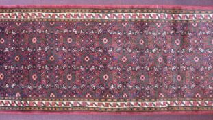 A North-West Persian Malayer runner, repeating stylised diamond motifs with petal motifs on a