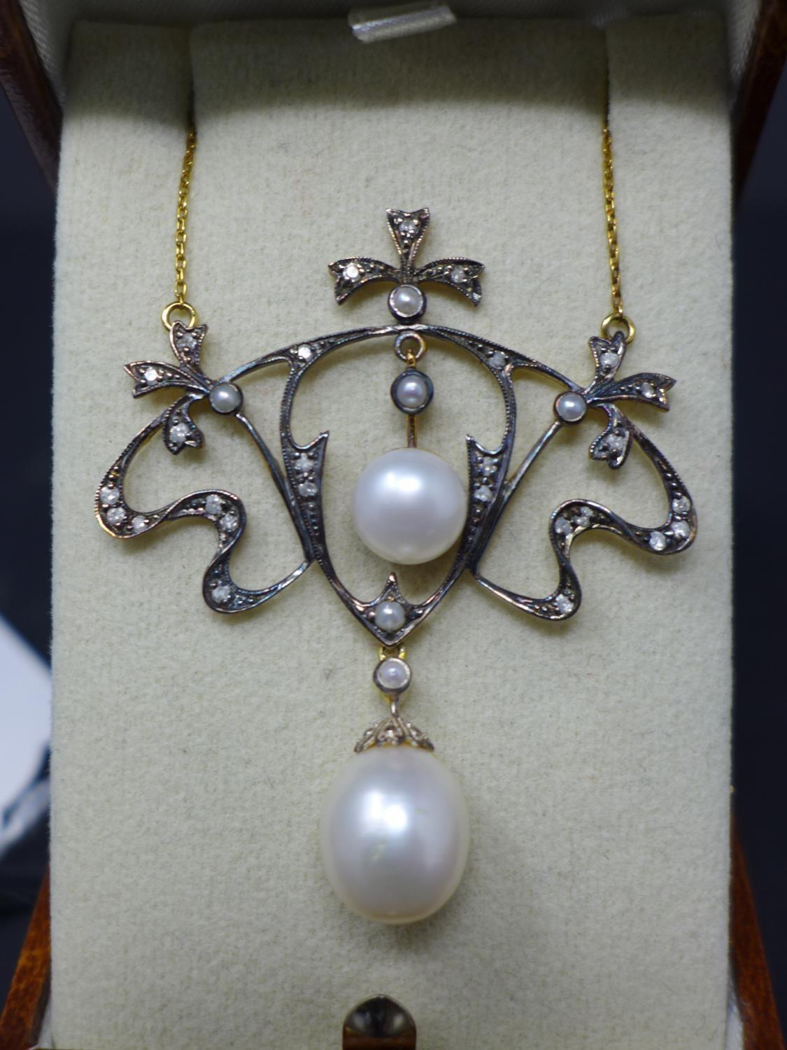 An Art Nouveau style necklace set with diamonds, seed pearls and cultured pearls, on a 9ct yellow