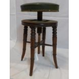 A 19th century mahogany adjustable stool, with studded green leather seat raised on splayed legs