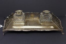 A 19th century silver desk stand, with pen rest and two cut glass inkwells, having pierced sides,