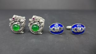 Two pairs of silver cufflinks, to include one set modelled as dragons set centrally with emeralds