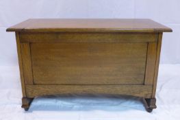 An Arts & Crafts oak coffer raised on castors, H.55 W.91 D.43cm