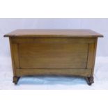 An Arts & Crafts oak coffer raised on castors, H.55 W.91 D.43cm