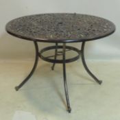 A cast aluminium garden dining table, H,72 D.105cm