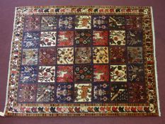 A Central Persian Bakhtiari rug, panels of animal and petal motifs repeating accross the field,