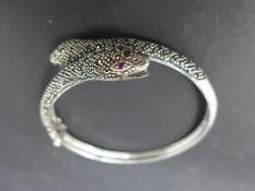 A white metal and marcasite snake bangle with ruby eyes