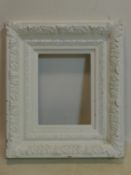 A white painted ornate picture frame, 78 x 66cm