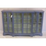 A large blue painted breakfront bookcase, H.101 W.161 D.40cm