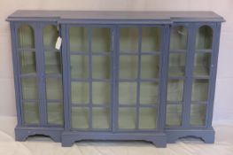 A large blue painted breakfront bookcase, H.101 W.161 D.40cm