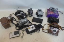 A collection of vintage cameras to include Halina, Palmat and Praktica