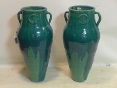 A pair of Persian green glazed Sharab wine vessels, H.90cm