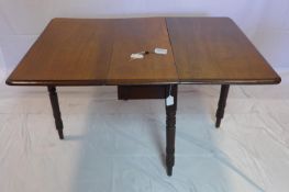A 19th century mahogany drop leaf dining table, raised on turned legs, H.69 W.134 D.97cm