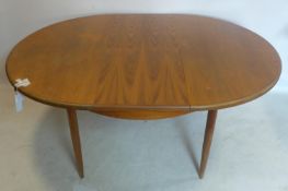 A 20th century G-plan teak extending dining table, with butterfly leaf, raised on tapered legs, H.74