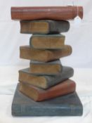 A lamp table modelled as a stack of books, H.51 W.33 D.34cm