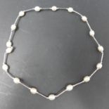 A cultured pearl necklace with silver spacers and clasp