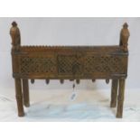 A 20th century Indonesian carved teak side cabinet with horse head finials, H.72 W.82 D.32cm