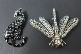 Two white metal brooches, to include one modelled as a leopard, H.5 W.2.5cm; the other modelled as a