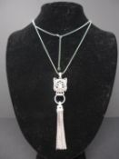 A white metal Cartier style pendant necklace, having panther pendant with emerald eyes