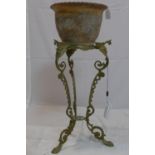 A Georgian style brass jardiniere stand, with scrolling supports raised on lion paw feet, H.56cm,