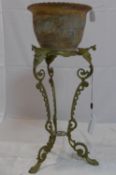 A Georgian style brass jardiniere stand, with scrolling supports raised on lion paw feet, H.56cm,