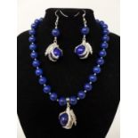 A lapis lazuli suite, to include lapis lazuli beaded bracelet, a beaded necklace and a pair of