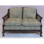 An Edwardian mahogany bergere sofa in the Chippendale manner