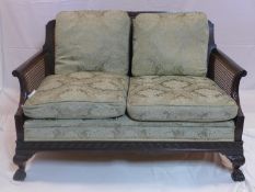 An Edwardian mahogany bergere sofa in the Chippendale manner