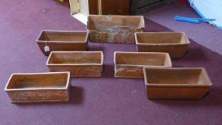 Seven terracotta planters