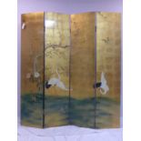 A Chinese four panel folding room screen, decorated with cranes and flowers on a gilt ground to