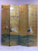 A Chinese four panel folding room screen, decorated with cranes and flowers on a gilt ground to