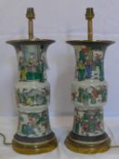 A pair of 19th century Chinese crackle glazed vases, hand painted with figures in courtyard