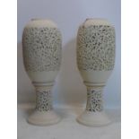 A pair of Middle Eastern pottery vases on stands, with pierced decoration, H.88cm