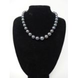 A black cultured pearl necklace with 9ct gold ball clasp