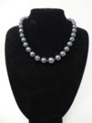 A black cultured pearl necklace with 9ct gold ball clasp