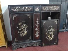 A 19th century Chinese hardwood cabinet, with mother of pearl inlay, raised on carved and pierced