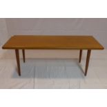A 20th century teak coffee table raised on tapered legs, H.47 W.131 D.52cm