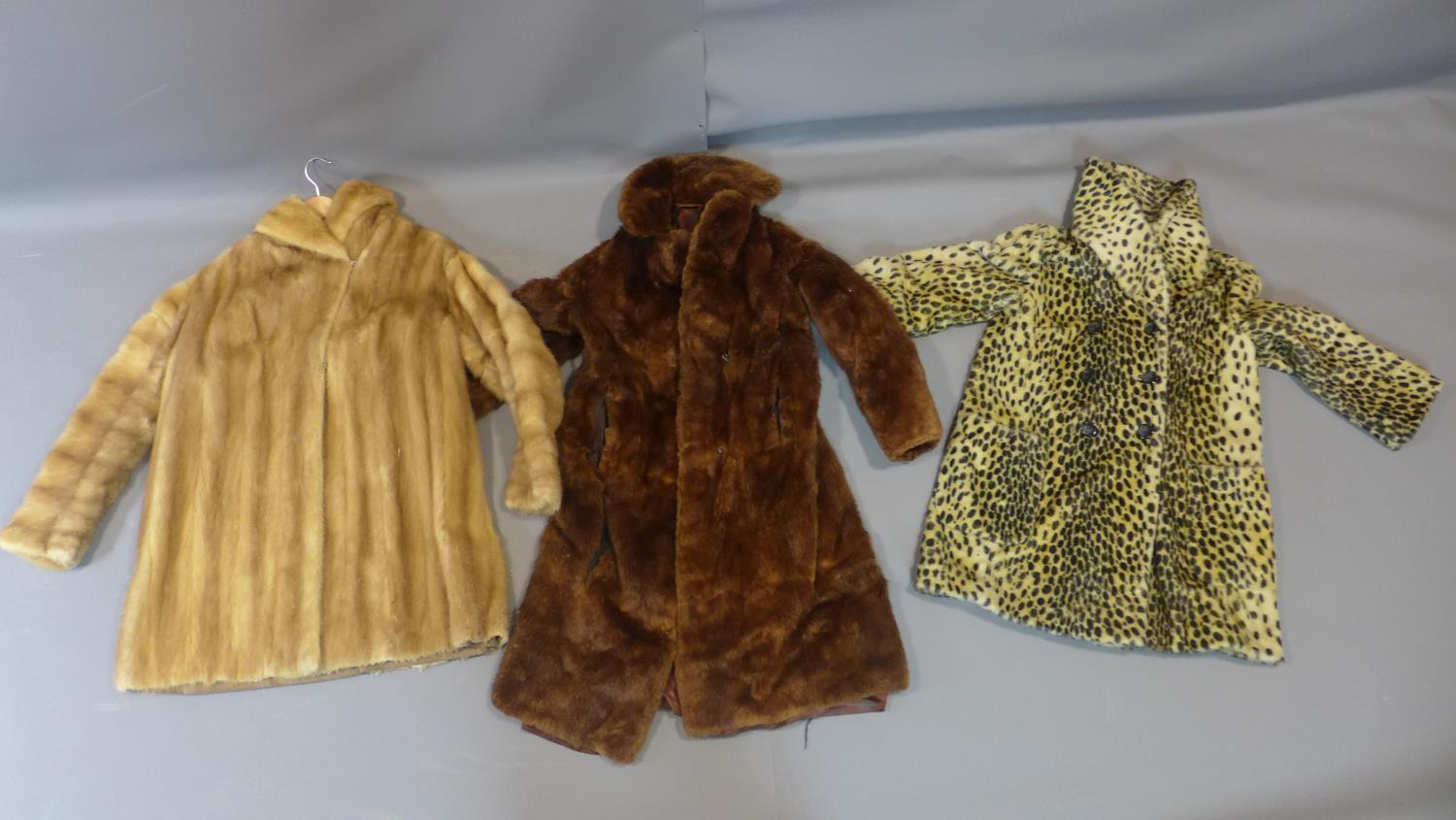 Two vintage fur jackets together with a faux cheetah fur jacket