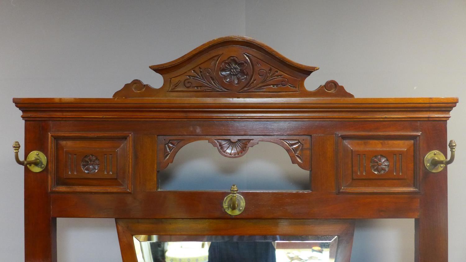 A Victorian Aesthetic mahogany hallstand, having shield mirror with bevelled plate, with single - Image 4 of 6