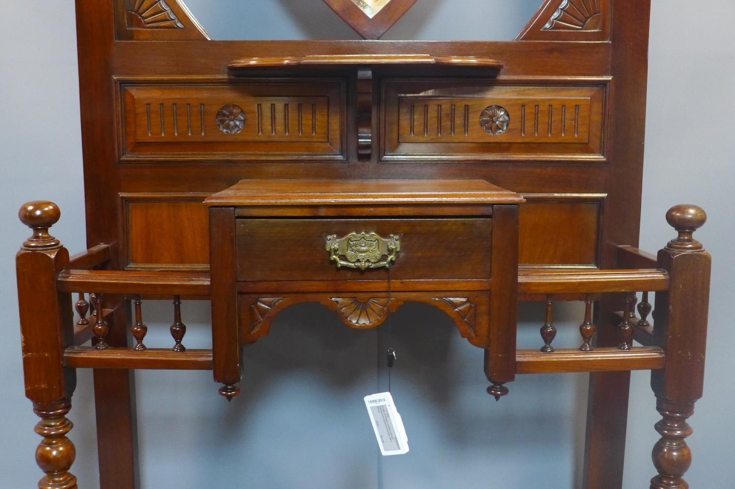 A Victorian Aesthetic mahogany hallstand, having shield mirror with bevelled plate, with single - Image 6 of 6