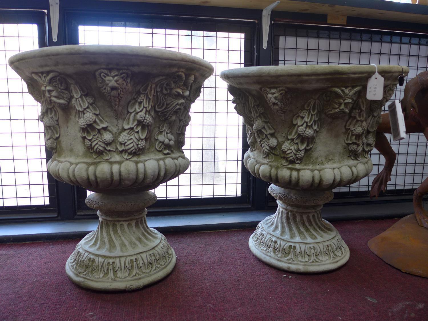 Two reconstituted stone vases, decorated with floral swags and masks, H.58cm Diameter 52cm (2)