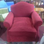 A Victorian style burgundy upholstered club armchair on mahogany turned supports. H.90 W.90 D.96cm